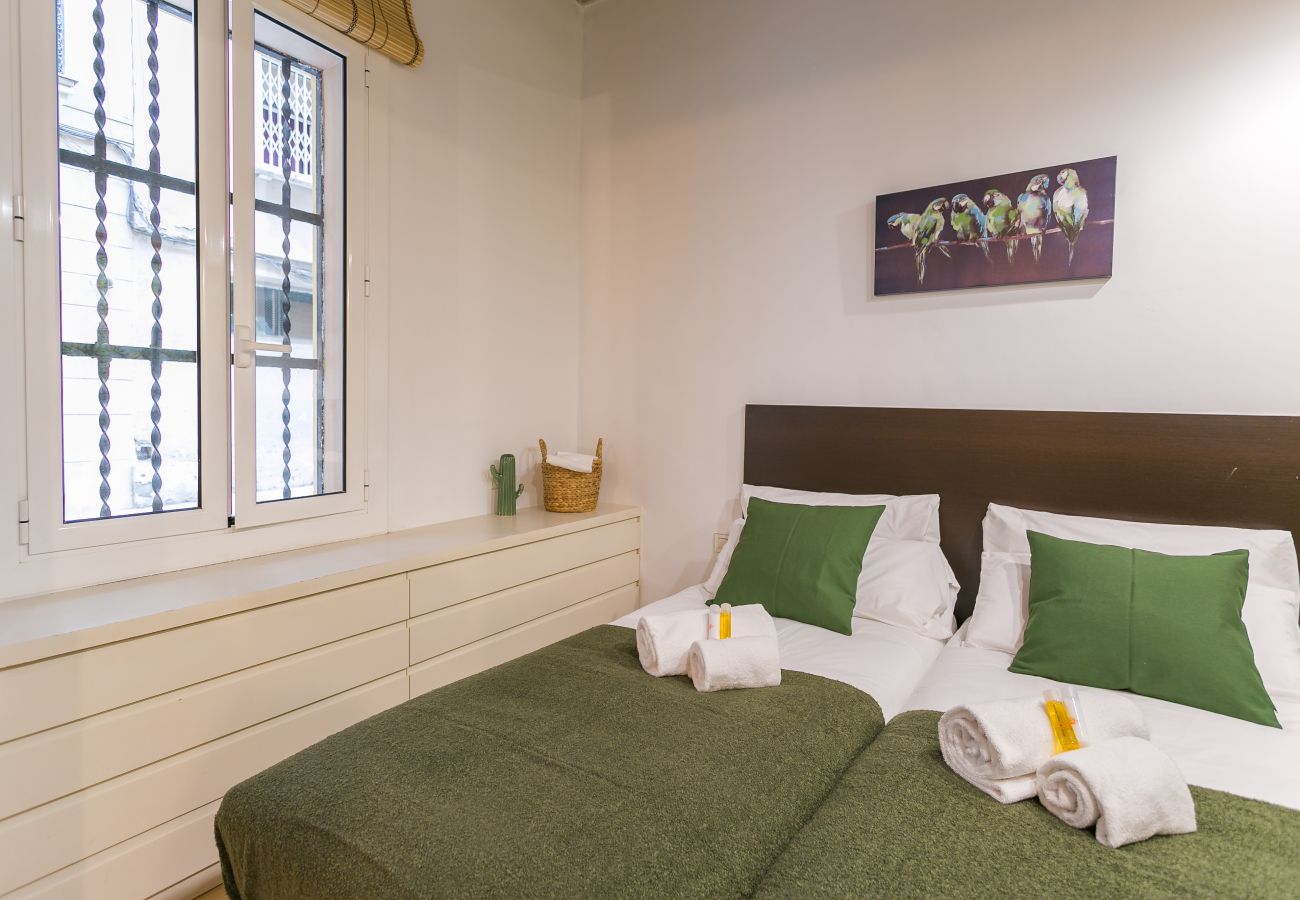 bedroom with 2 single beds, wardrobe and exterior window