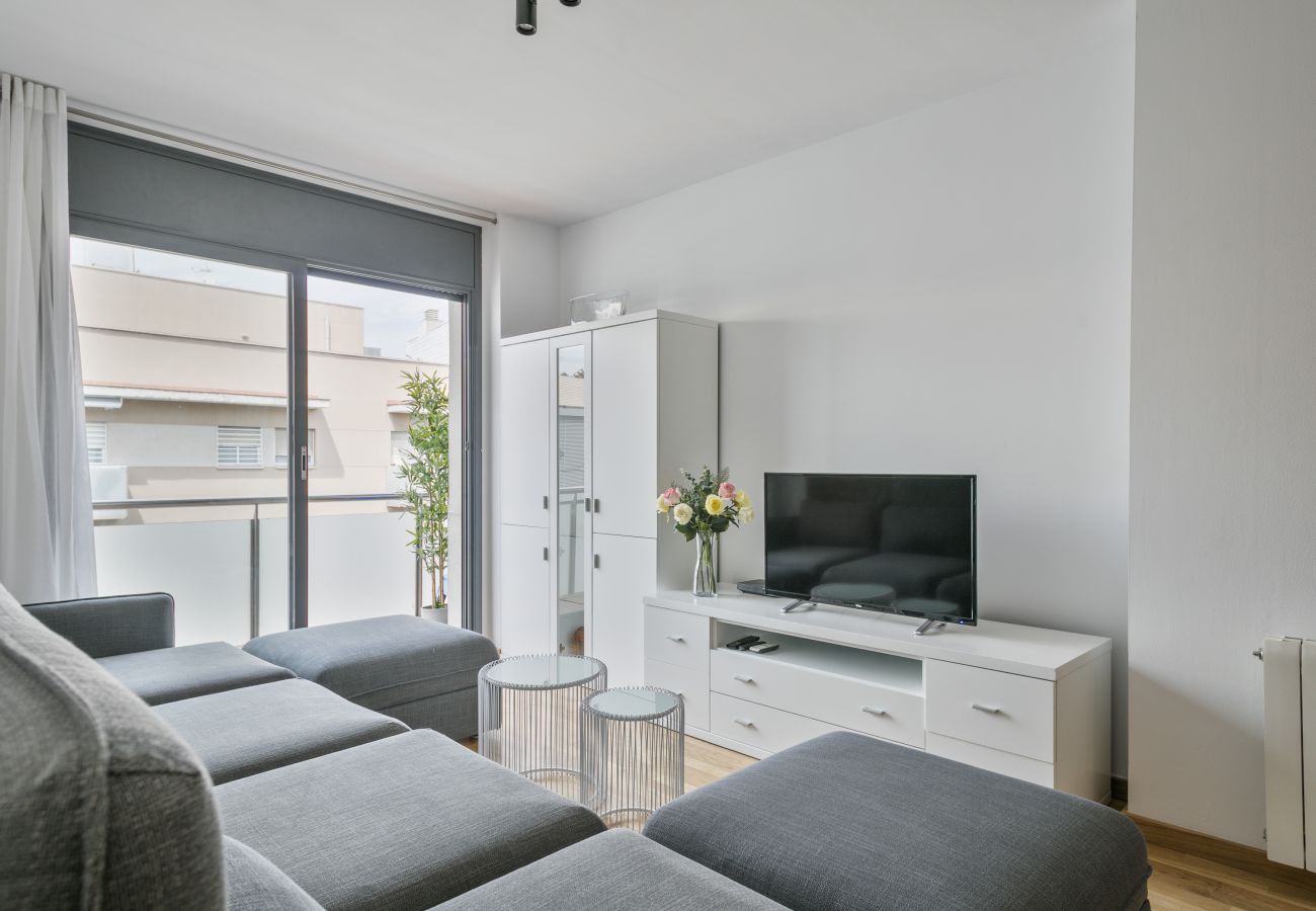 bright living room with TV and exit to the balcony in 3-bedroom apartment