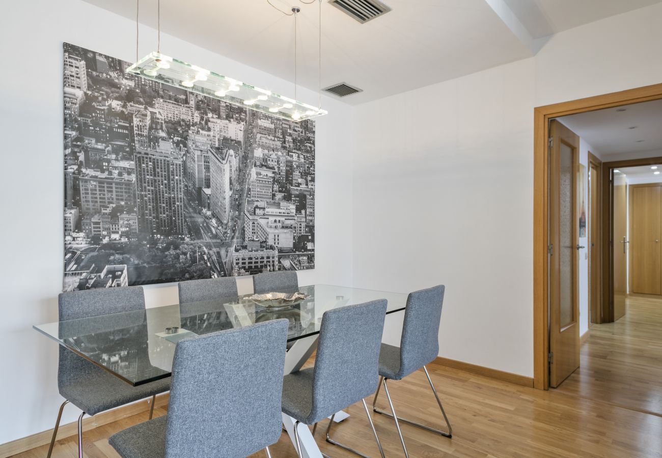 glass dining table with 6 seats in 3-bedroom apartment in PobleNou